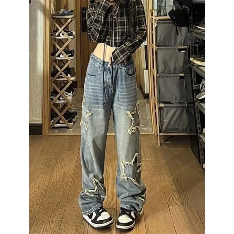 Blue women's high-waisted straight-leg jeans laid flat, showing the front design and medium wash denim texture.