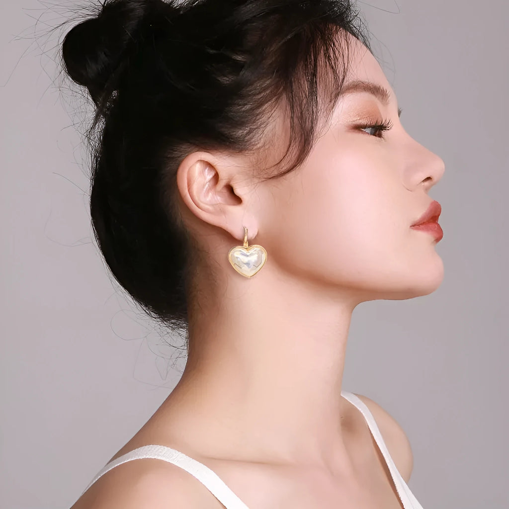 Gold coloured women's clip-on earring made from alloy with metal design details.