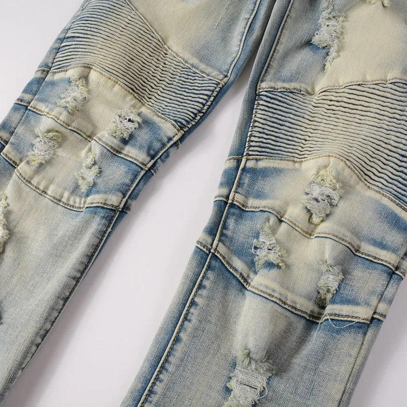 Light blue men's slim fit distressed jeans with hand-frayed details and a light straight leg cut.