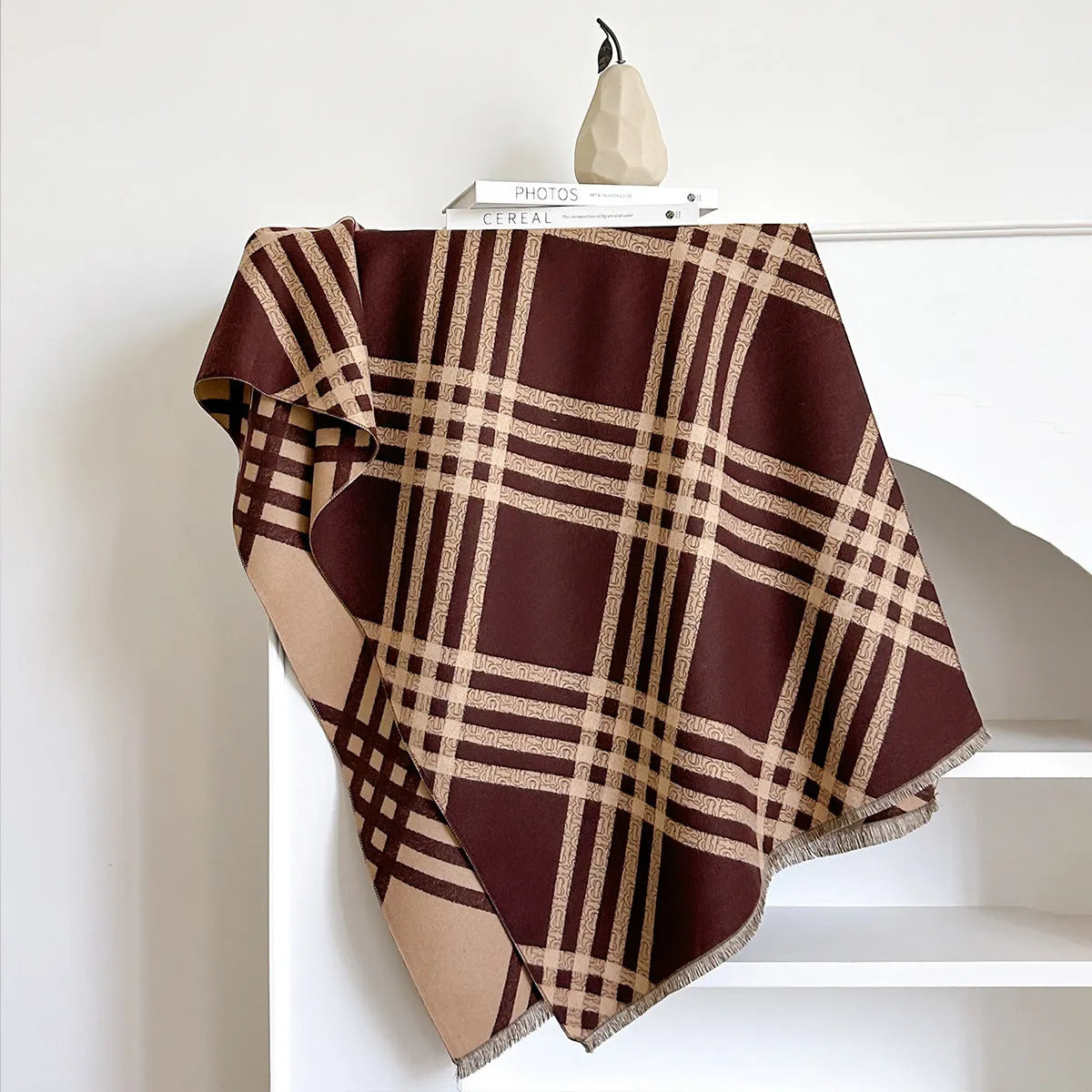 Mid-length brown cashmere-like scarf with tassel ends laid flat.