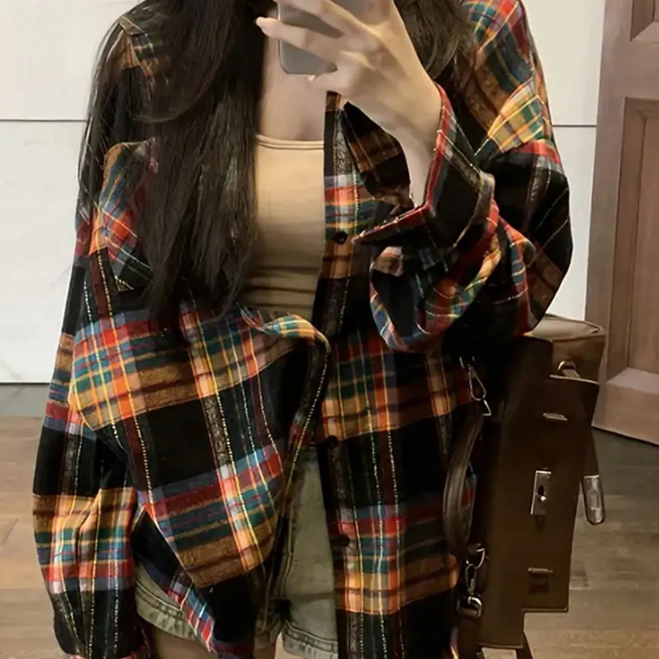 Women's loose fit cotton plaid shirt in black, shown with long sleeves and a button front.