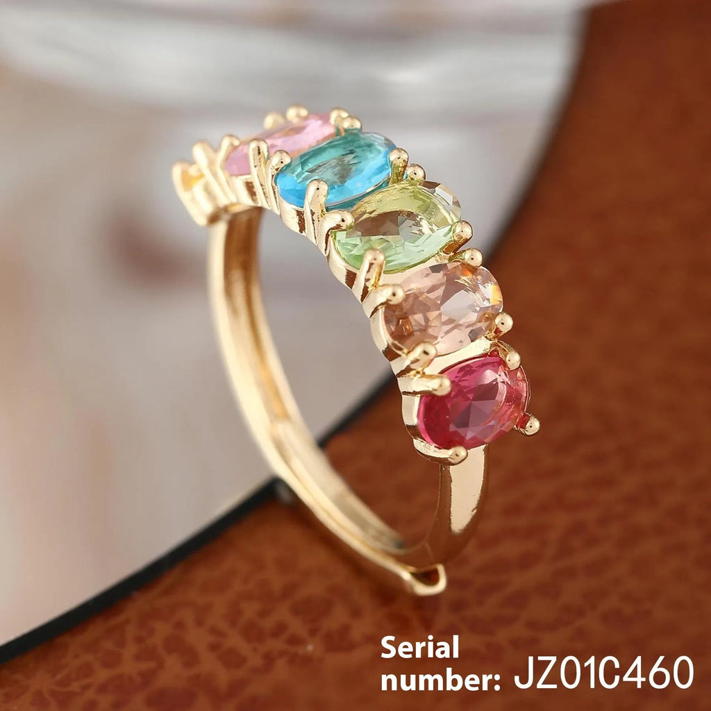 Gold coloured adjustable zircon ring for women on a simple background