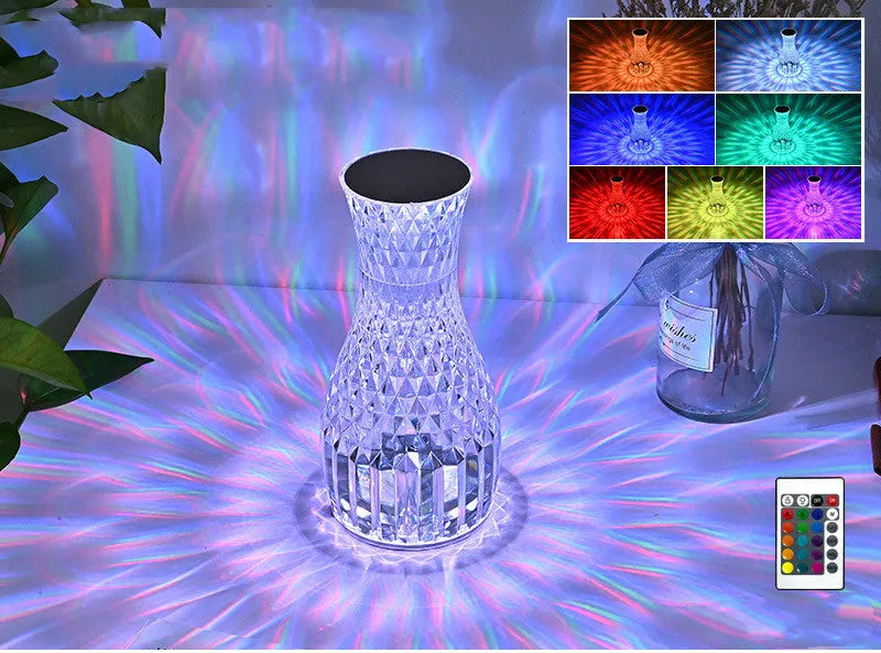 Vase-shaped crystal table lamp with LED lights and remote control on wooden bedside table