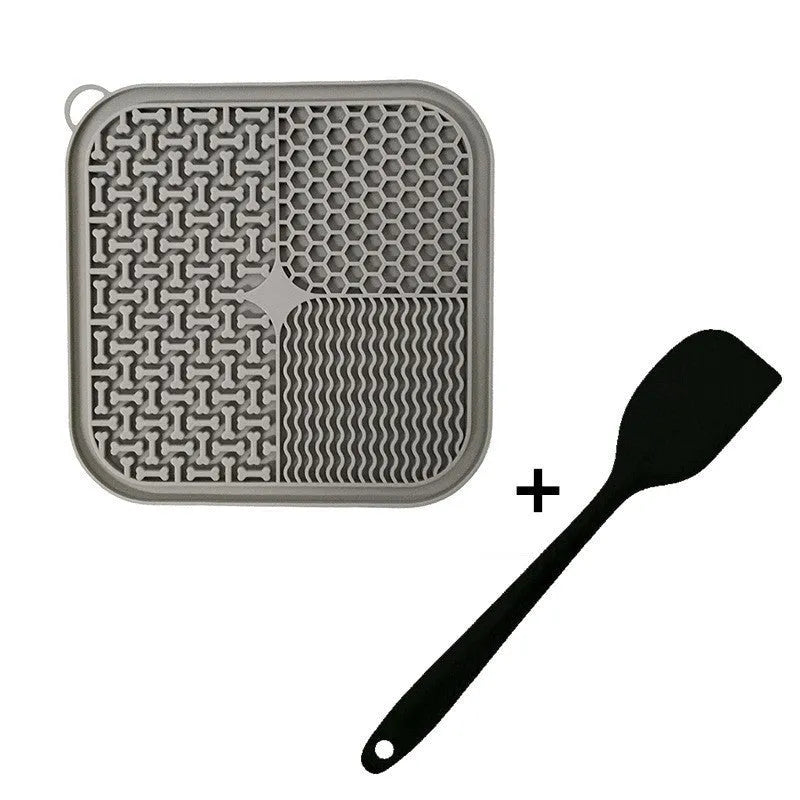 Square orange silicone dog licking mat with suction cups on back and textured surface