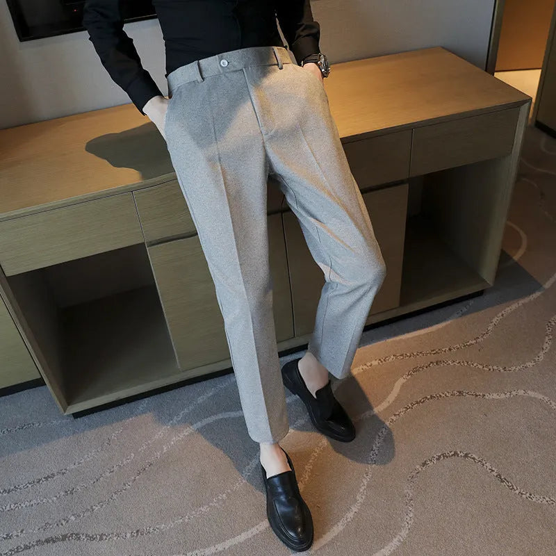 Brown straight leg corduroy trousers with elastic waistband on hanger