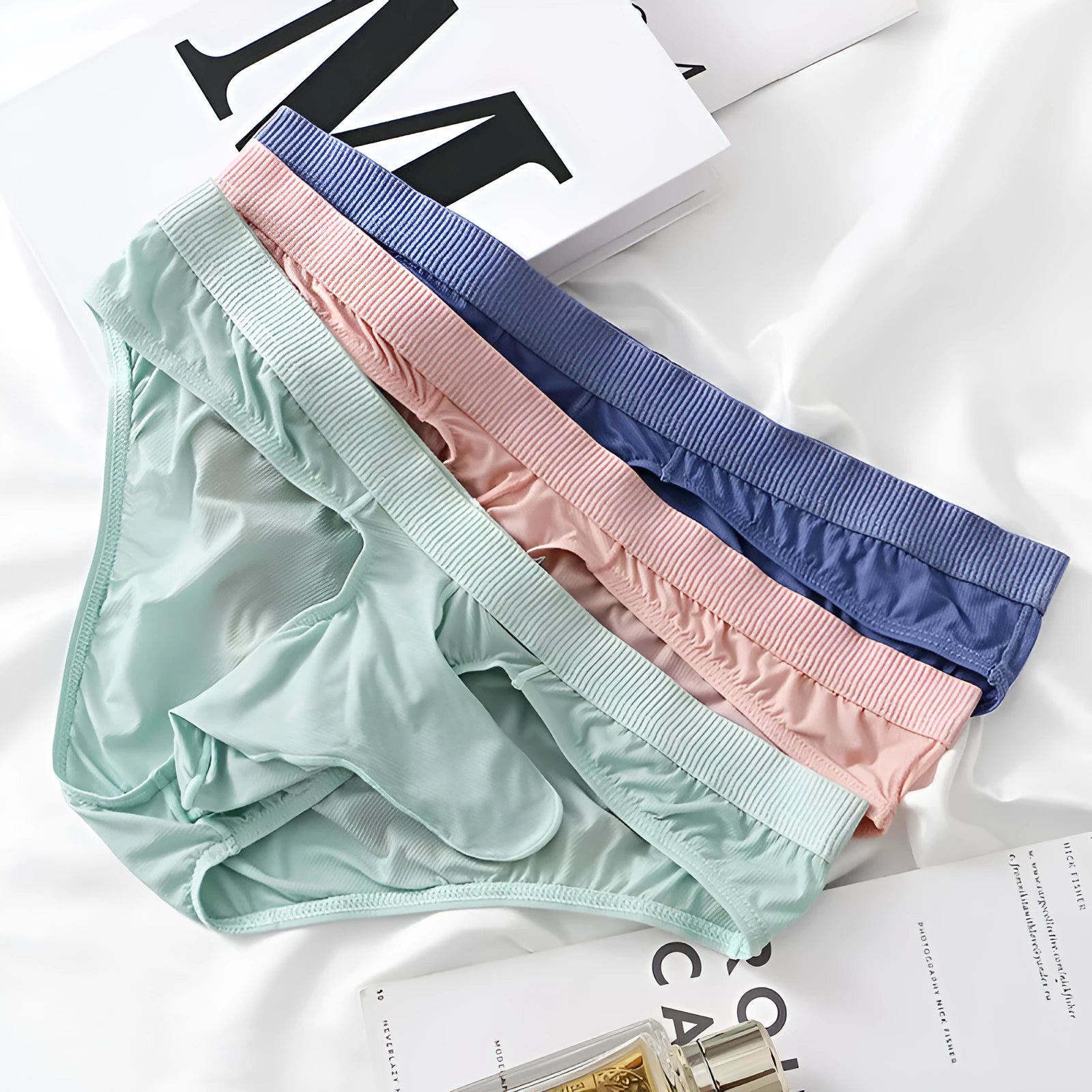 Men's low waist ice silk briefs in multiple colours showing the briefs style fit.