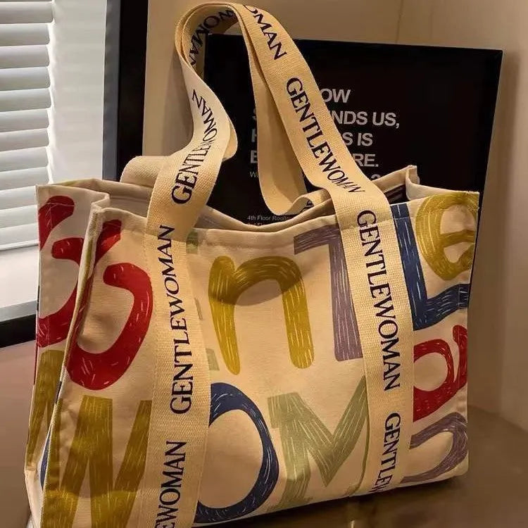 Large canvas tote bag with printed design, shown in available colour and pattern options.