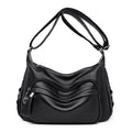 Large blue women's shoulder bag with multiple internal compartments and crossbody strap
