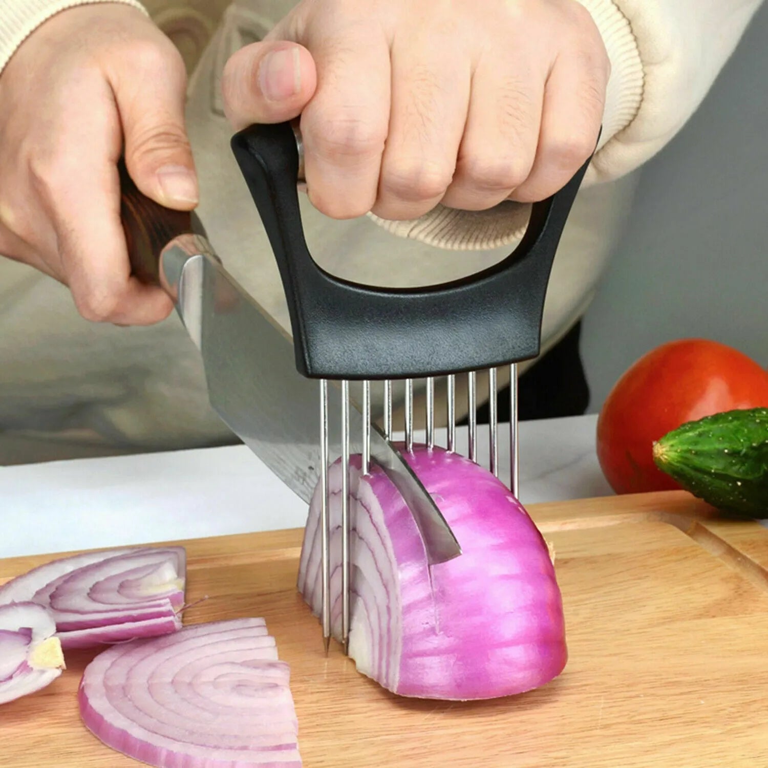 Stainless steel onion slicer tool with needles on a white ABS base.