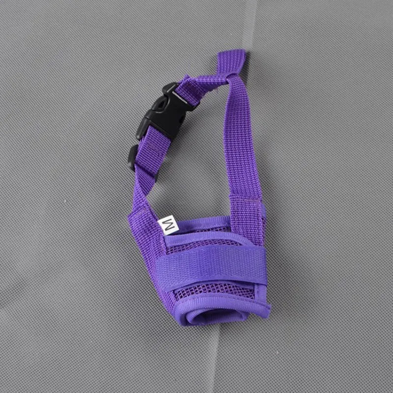 A black adjustable plastic dog muzzle shown on a size chart with options for red, blue, pink, and purple.