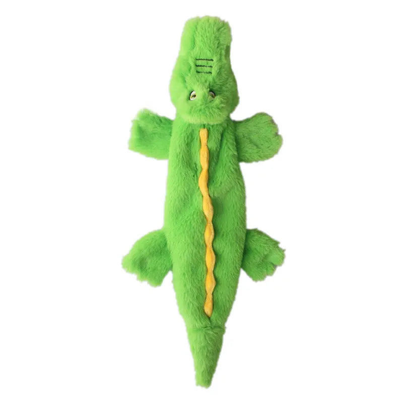 Green crocodile-shaped plush dog toy with no stuffing, squeaker in head, and crinkle paper tail