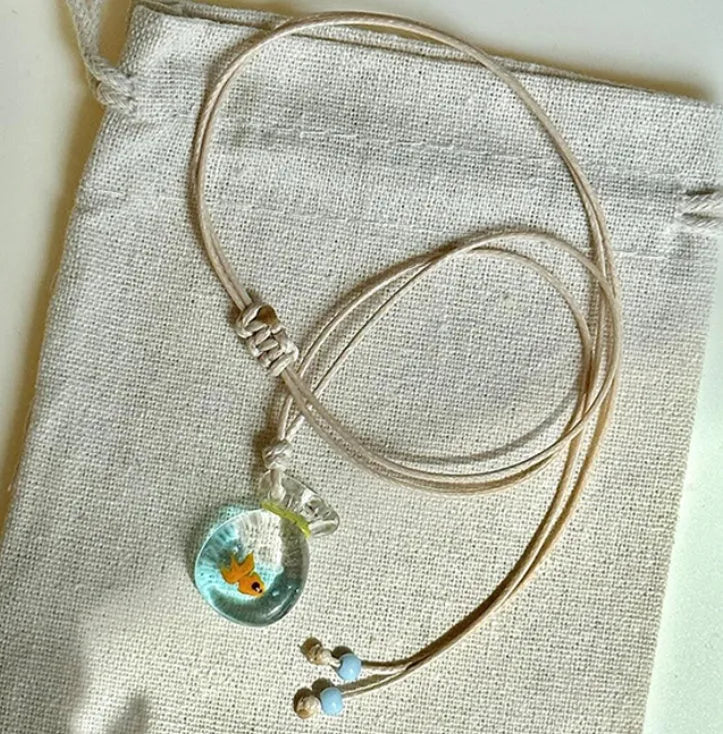 Women's joker charm necklace with coloured glaze pendant on a cotton and linen clavicle chain.