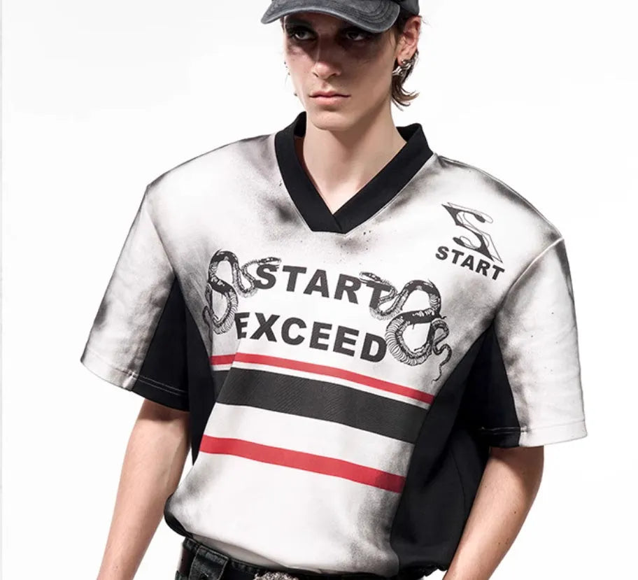 Women's short sleeve V-neck top with a grey letter snake pattern print and padded shoulders.