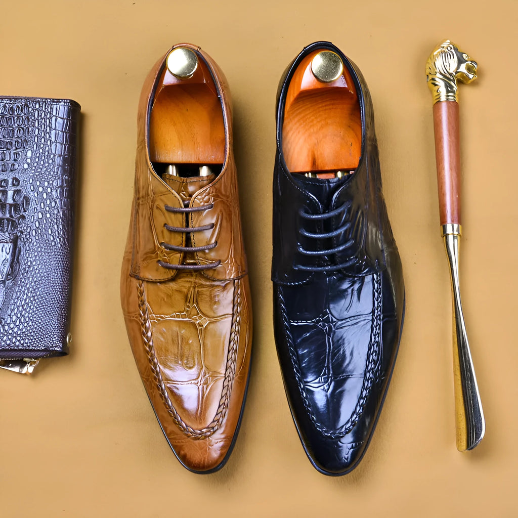 Black men's leather loafers with a silver horsebit buckle on a pointed toe, side view.