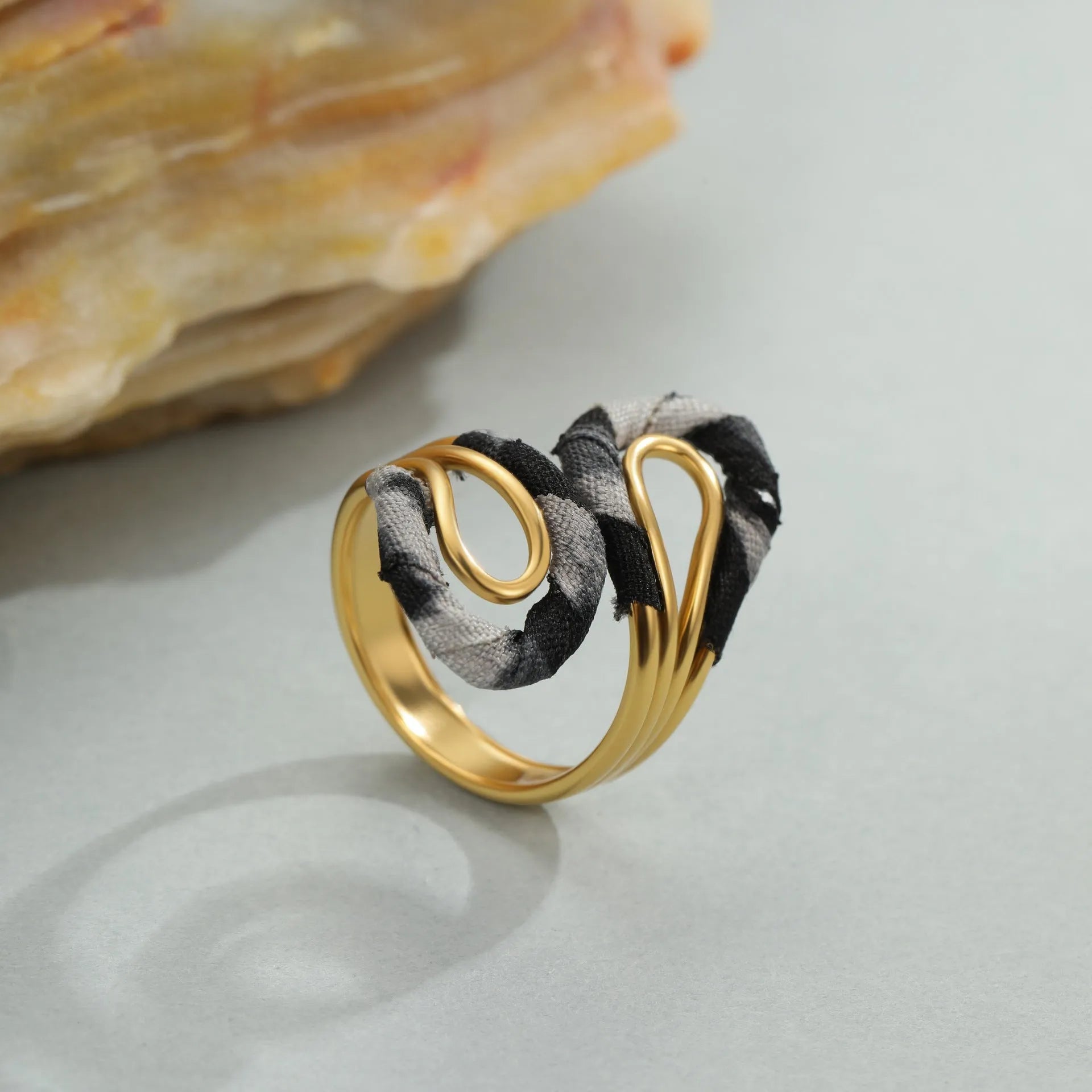 Stainless steel open mouth ring with leopard print and geometric heart or star shape design.