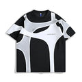 Loose black t-shirt showing double stitching detail forming a padded strap over the shoulder