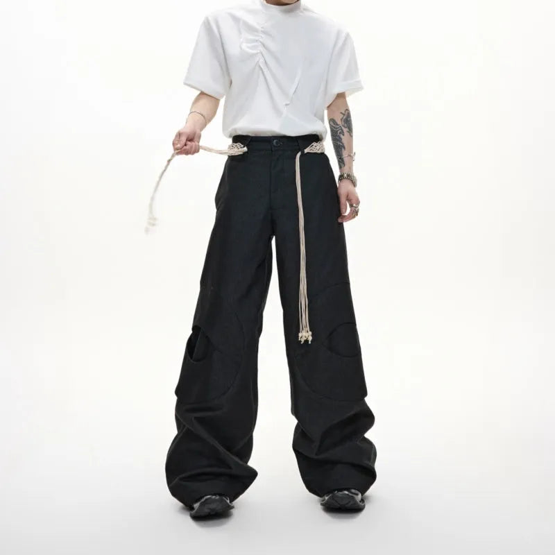 Men's dark blue loose fit straight-leg jeans with decorative belt stitching and zipper details.