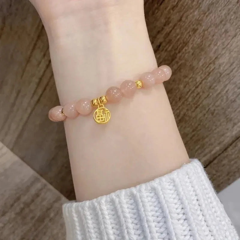 Chinese style handmade glass bead bracelet with bamboo joint elements on a white background.