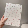 Transparent floral tri-fold tablet case for iPad showing magnetic closure and decorative pattern