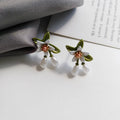 Women's alloy flower earrings with sterling silver needle contrasting colour detail, shown in clip-on and stud styles