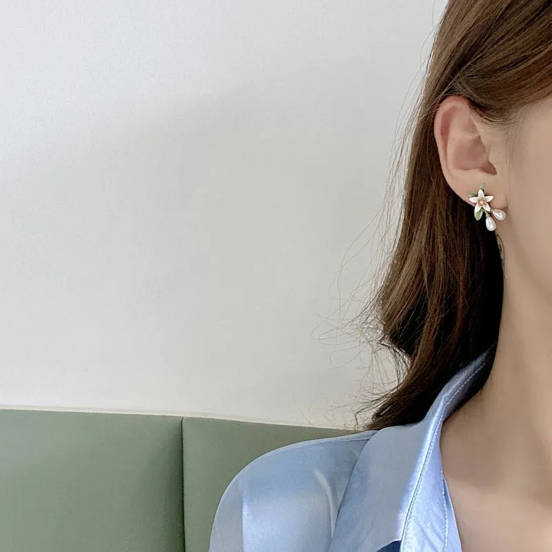Women's alloy flower earrings with sterling silver needle contrasting colour detail, shown in clip-on and stud styles