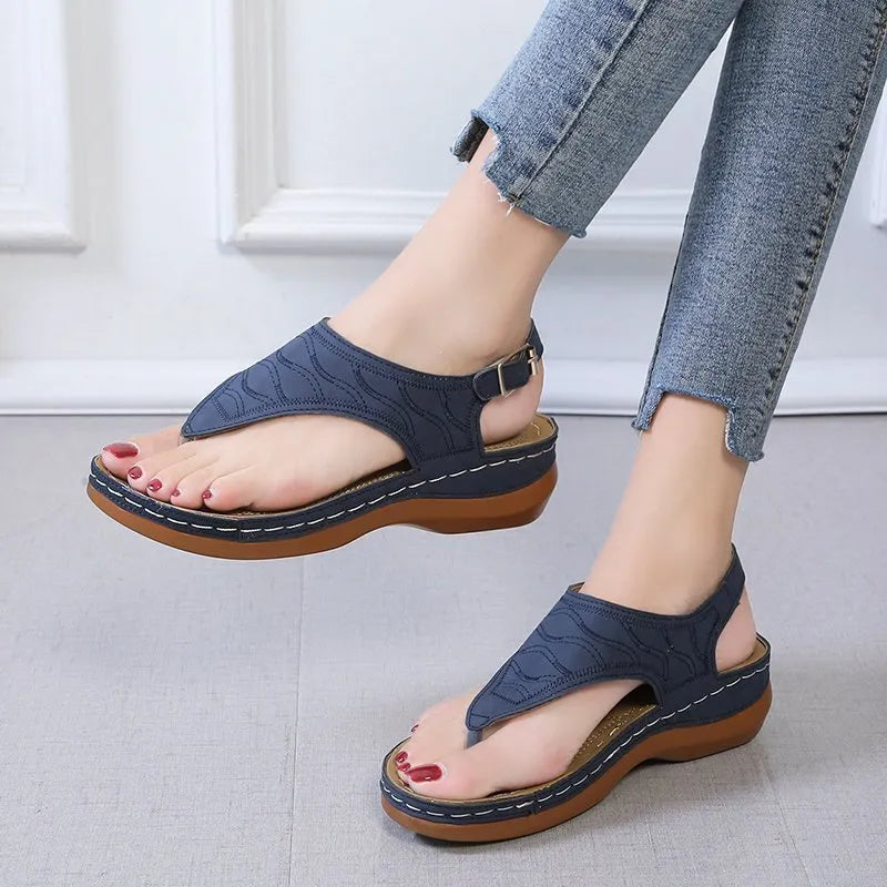 Women's casual wedge-heel sandals with adjustable buckle strap in a solid colour.