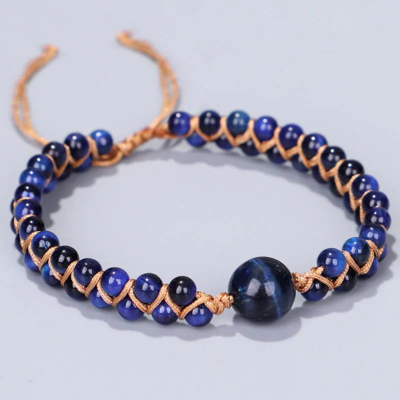 Handwoven geometric pull bracelet made from blue Tigereye stone beads with amethyst details