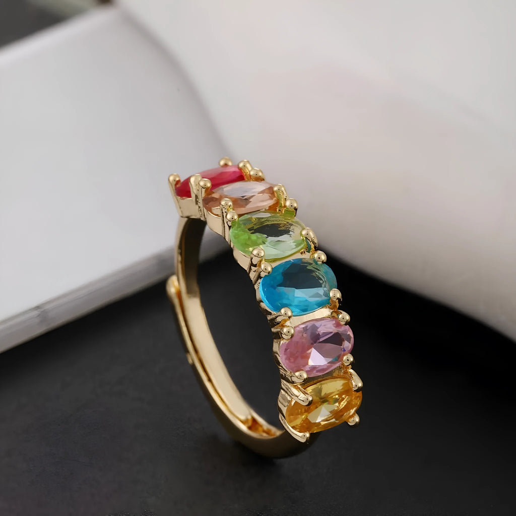 Gold coloured adjustable zircon ring for women on a simple background