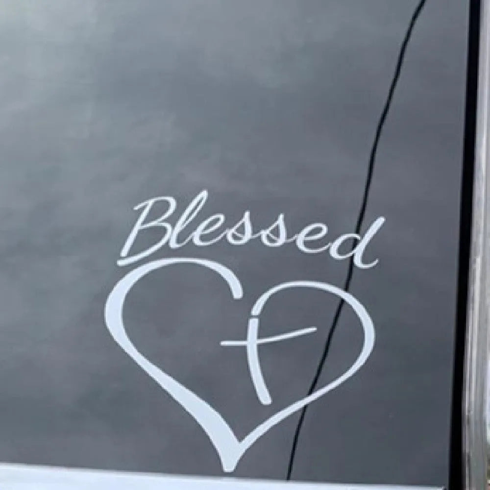 Large red heart-shaped sticker with the words Faith, Hope, Love printed on it.
