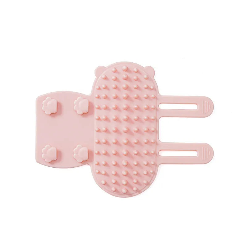 Silicone wall-mounted cat grooming brush with comb teeth and adjustable strap for table legs.