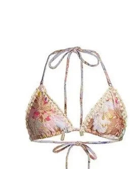 Women's creamy-white floral print bikini set with top, briefs, and skirt laid flat.