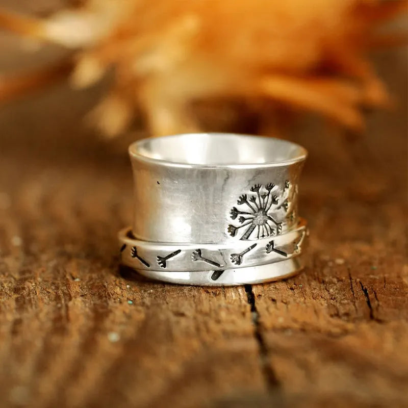 Silver rotatable flower ring in European American style with five size options displayed