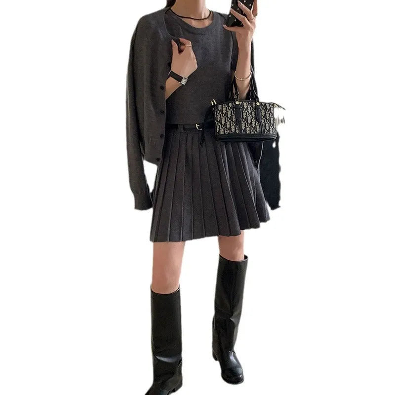 Women's black art retro knitted vest skirt and long sleeve cardigan two-piece set with belt.