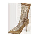 Gold pointed toe stiletto high heel sandals with a mesh upper and oversleeve design.