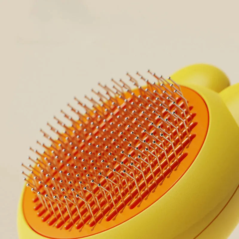 Green self-cleaning pet grooming brush with release button and stainless steel comb teeth.