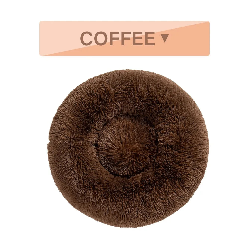 A round donut-shaped dog bed with a raised plush rim, shown in a light grey colour.