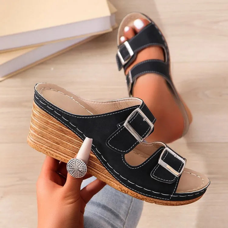 Women's creamy-white wedge beach slippers with a decorative belt buckle on the strap.