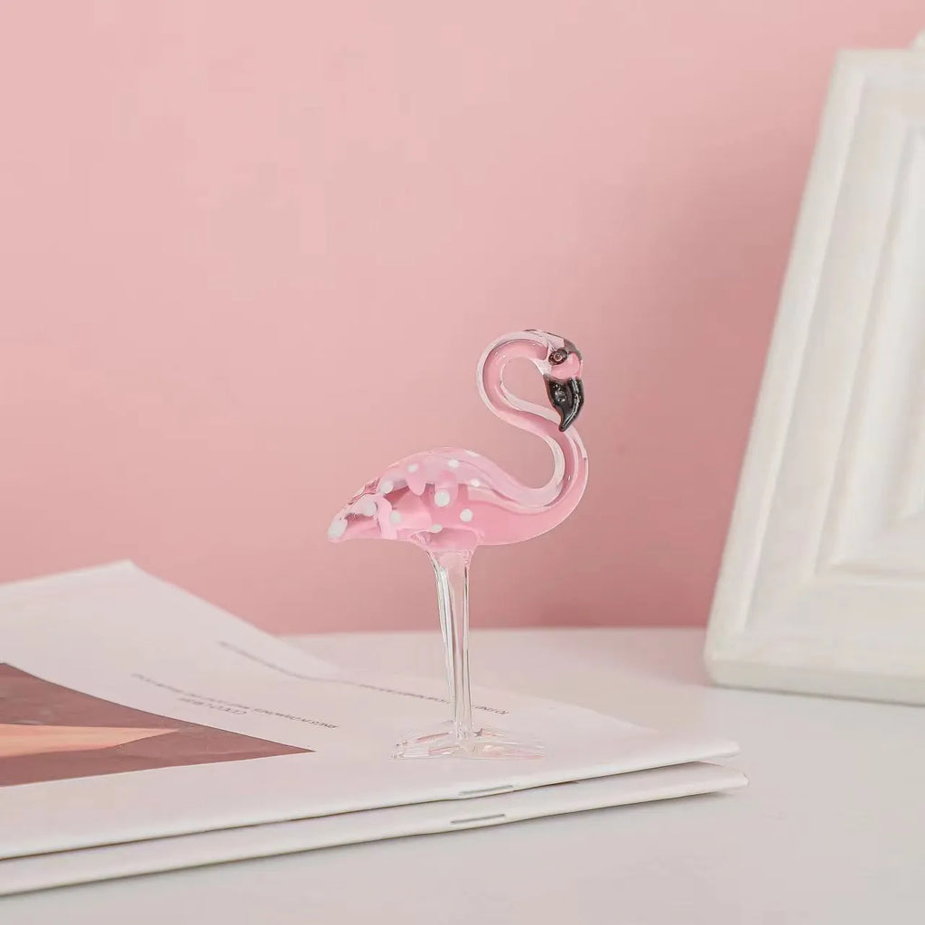 Pink flamingo crystal animal decoration on a tabletop in separate and juxtaposition styles.