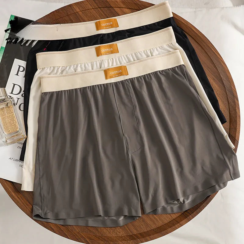 Three pairs of men's solid colour loose fit ice silk underwear in various colour combinations