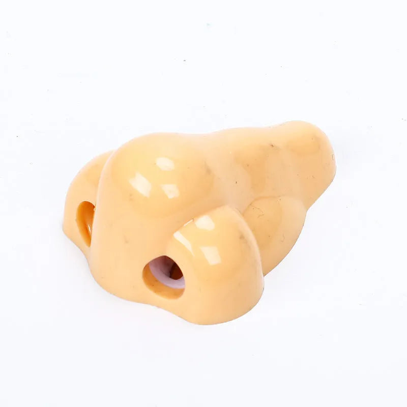 Flesh coloured geometry-shaped plastic pencil sharpener with big nostril opening