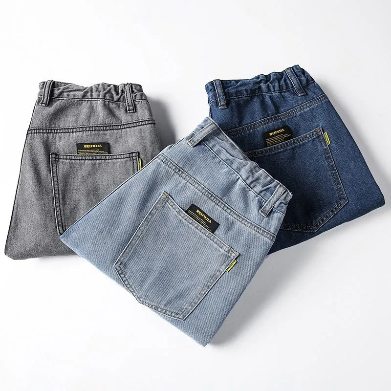 Men's loose straight jeans in dark blue, light blue, and grey colours showing mid waist and straight-leg cut