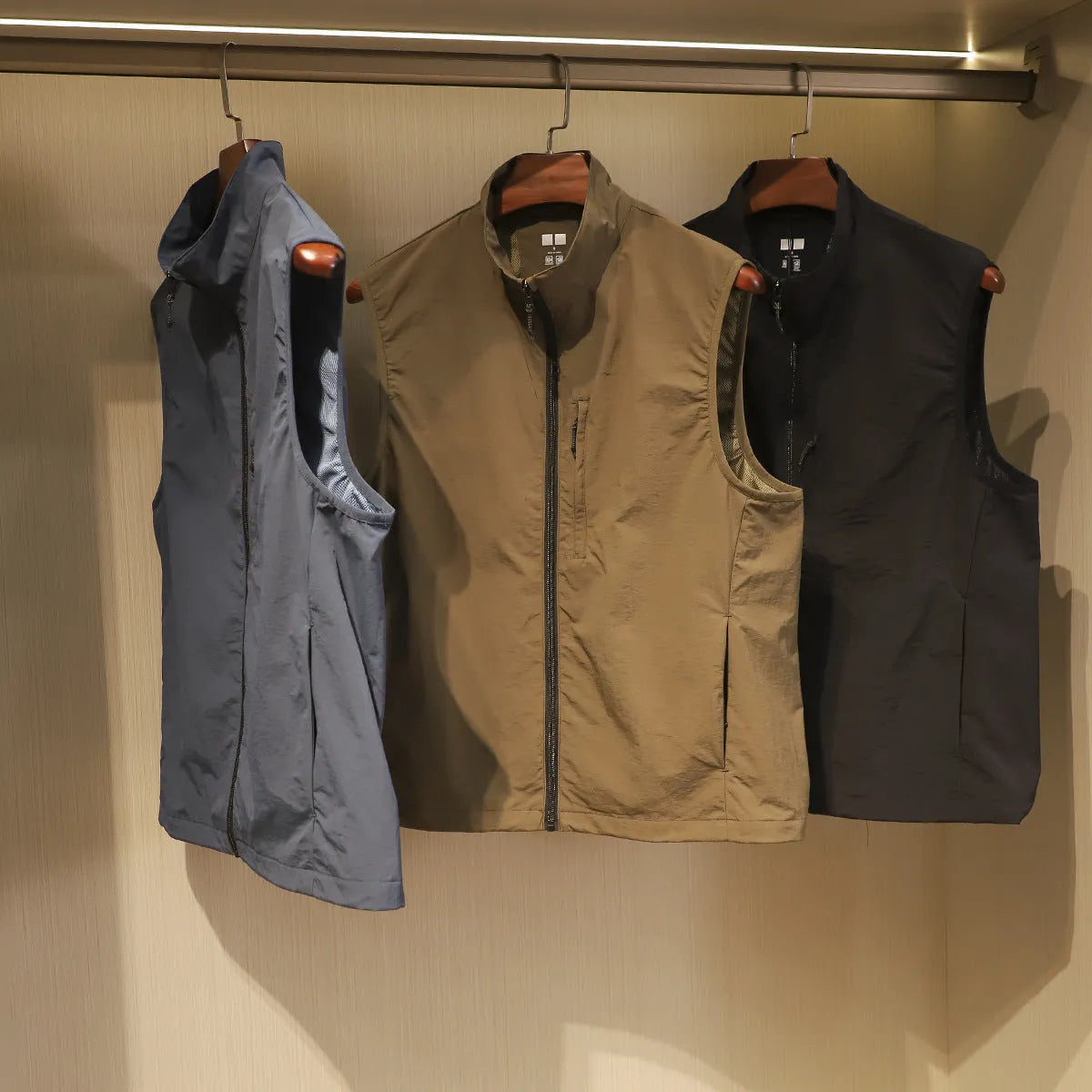 Men's straight-cut nylon vest in Army Green with side seam pockets.