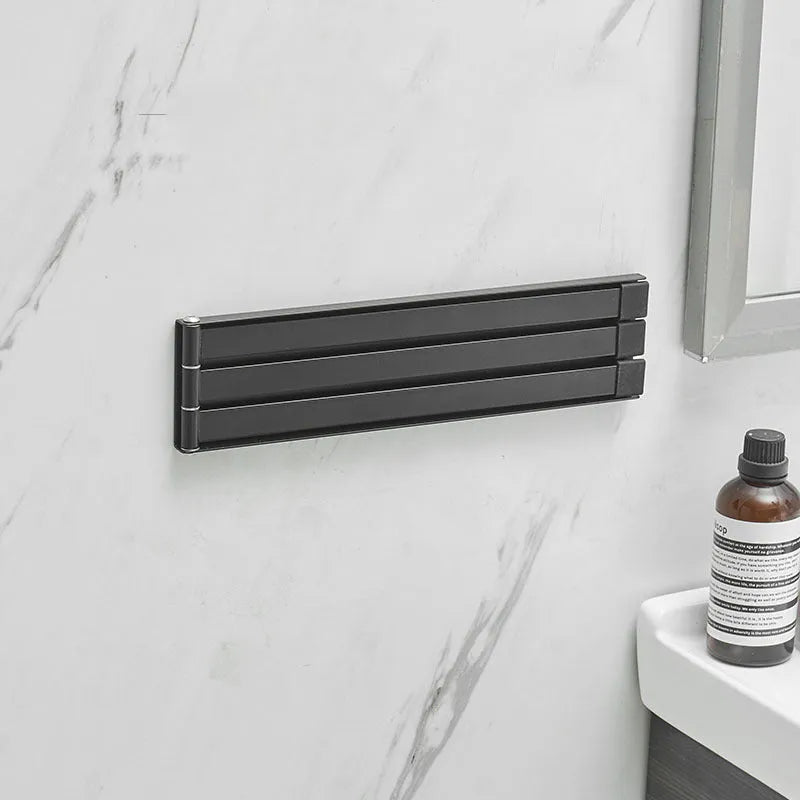 Nordic folding towel rack in carbon steel with black or white finish, mounted with adhesive without drilling