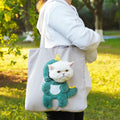 Canvas pet carrier backpack for cats and small dogs on a shoulder strap showing cartoon pattern options.