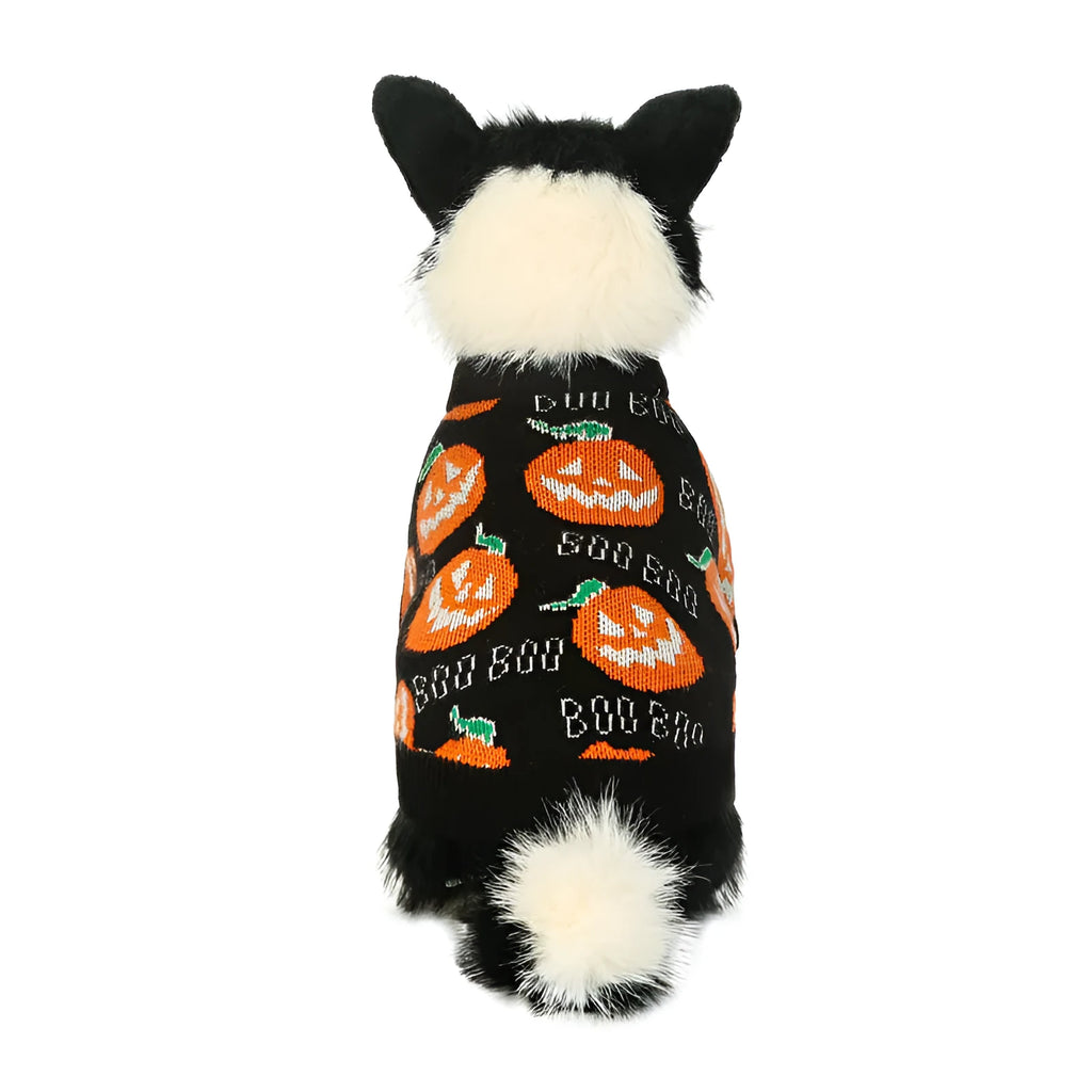 Black dog sweater with a large orange Halloween pumpkin pattern on the back, laid flat.