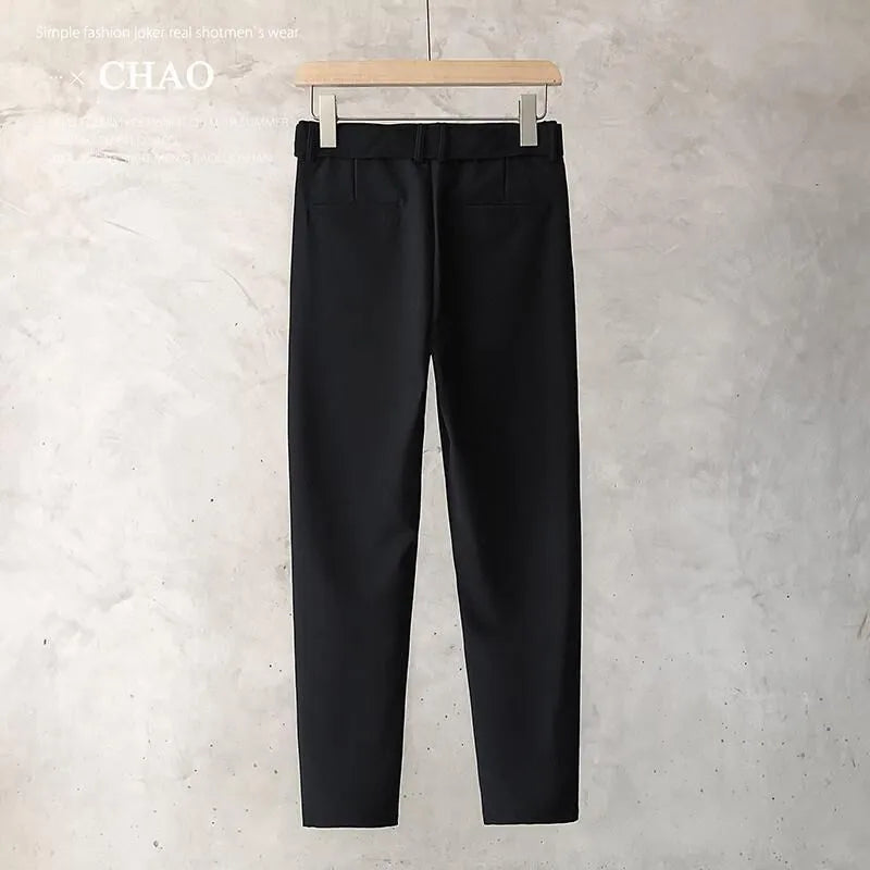 Boys slim straight-leg wool trousers in tapered cut, shown in black, on a hanger.