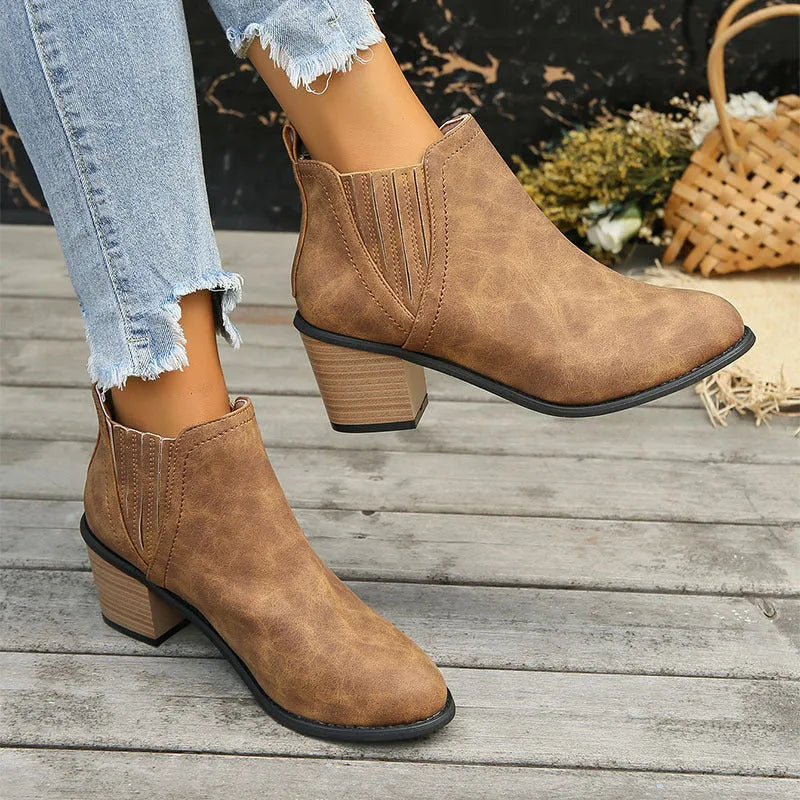 Women's black ankle boots with pointed toes and thick square low heels, slip-on design