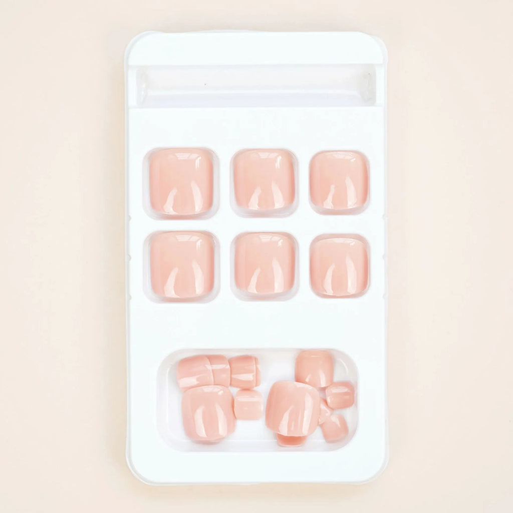 Finished plastic toe nail stickers in J-52 skin colour with adhesive glue for cosmetic application