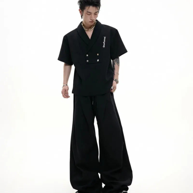 Men's dark grey cotton sports suit with padded shoulders, metal embellishments, V-neck, and matching shorts