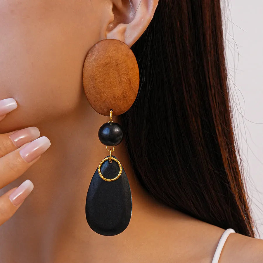 Women's brown-black wooden elliptical earrings with silver needle detailing